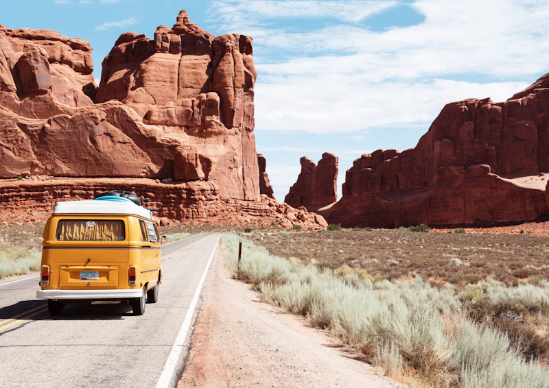 Towering red sandstone cliffs and houseboats in Lake Powell Utah